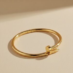 Golden nail bracelet, classic design on a white background.