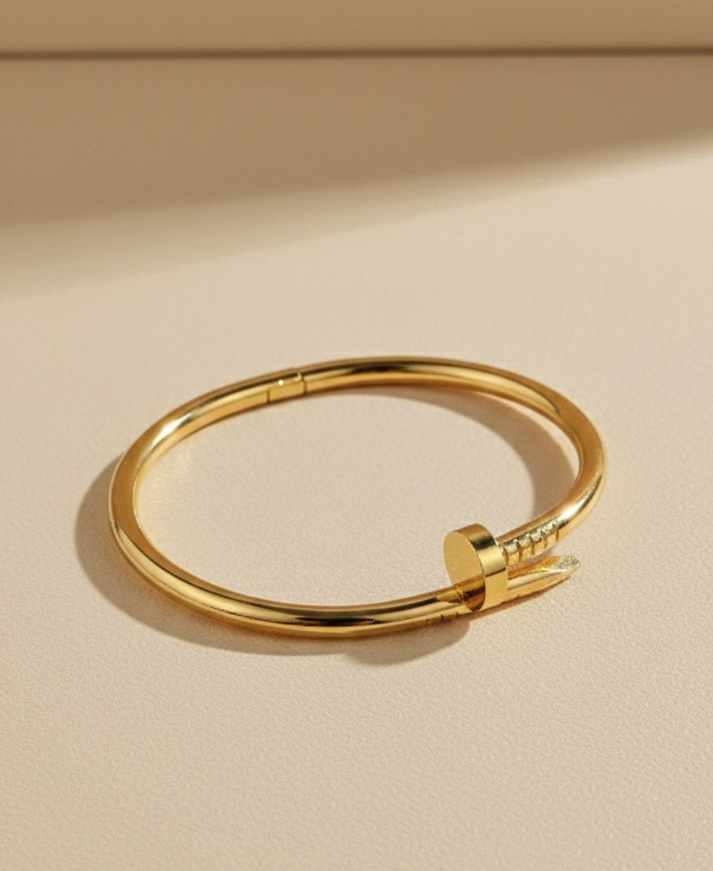 nbg Golden nail bracelet, classic design on a white background.