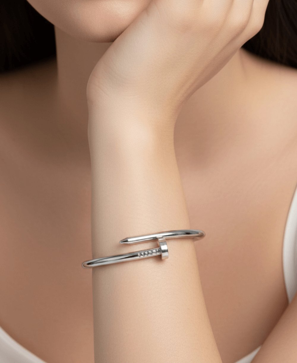 Silver nail bracelet, classic design on a white background.